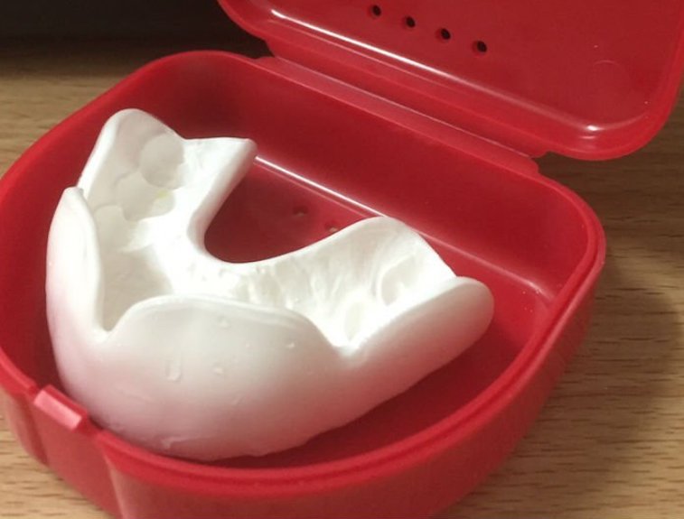 Van Noorden Labs custom fitted mouthguard in aerated case.